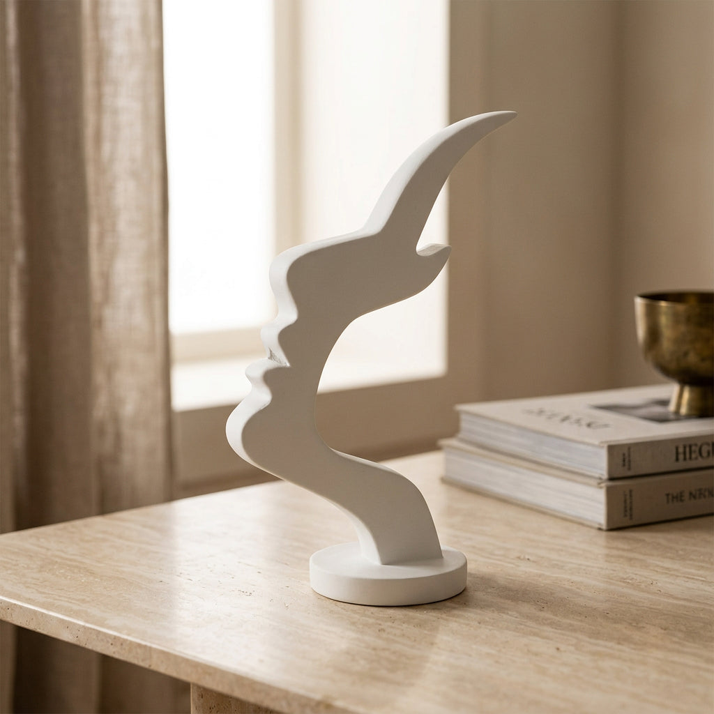 White abstract face-shaped eyeglass holder featuring a sculptural silhouette and round base in a modern home setting.