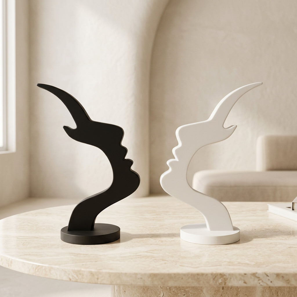 Black and white minimalist face eyeglass holders displayed side by side on a modern beige tabletop.