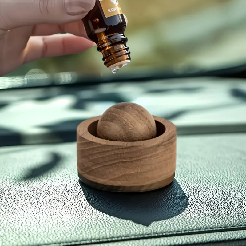 Compact wooden essential oil diffuser displayed on a minimalist beige tabletop. 